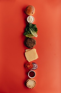 Photo by alleksana: https://www.pexels.com/photo/deconstructed-burger-on-red-surface-7497252/