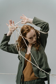 Photo by Ron Lach : https://www.pexels.com/photo/a-woman-with-ropes-around-her-body-9463001/